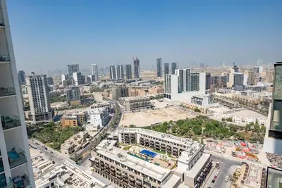 an aerial view of a city with tall buildings at Homes Beyond l 1BR Cozy Modern Escape in JVC in Dubai