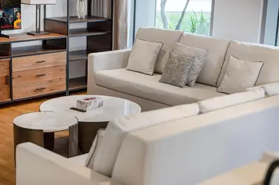 a living room with a white couch and a table at Luxury 2 Bedroom Apartment with Maids Room and Large Terrace in Dubai