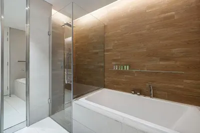 a bathroom with a bath tub and a shower at Luxury 2 Bedroom Apartment with Maids Room and Large Terrace in Dubai