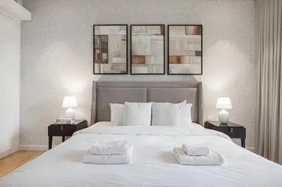 a bedroom with a large white bed with two pillows at Luxury 2 Bedroom Apartment with Maids Room and Large Terrace in Dubai