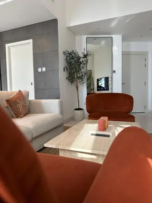 a living room with two couches and a mirror at Stunning 1-Bedroom Apartment , Full Marina View in Dubai