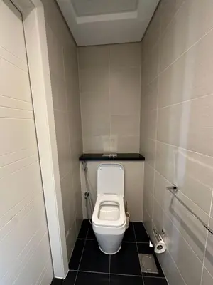 a small bathroom with a toilet in a stall at Stunning 1-Bedroom Apartment , Full Marina View in Dubai