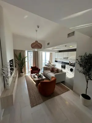 a living room with a couch and a table at Stunning 1-Bedroom Apartment , Full Marina View in Dubai