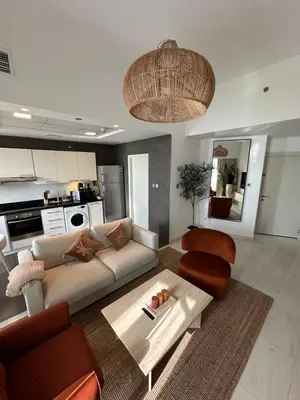 a living room with a couch and a table at Stunning 1-Bedroom Apartment , Full Marina View in Dubai