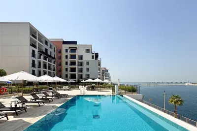 a swimming pool on the side of a building at PVH - Breezy 1BR with Partial Sea View - La Sirene in Dubai