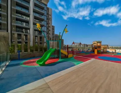 a playground with a green slide in a building at Stylish Dubai Hills Studio with Rooftop Pool and Gym in Dubai
