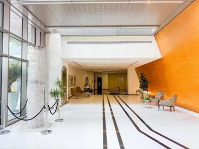 an office lobby with a large orange wall at Chic Stay in Sparkle Towers in Dubai