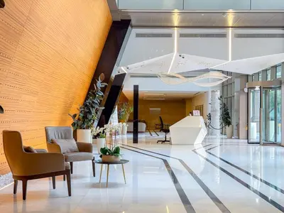 a lobby with chairs and tables in a building at Chic Stay in Sparkle Towers in Dubai