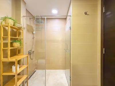 a shower with a glass door in a bathroom at Chic Stay in Sparkle Towers in Dubai