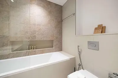 a bathroom with a tub and a toilet and a sink at Luxury 2BR Downtown Dubai Near Dubai Mall in Dubai