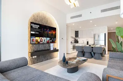 a living room with a couch and a fireplace at Luxury 2BR Downtown Dubai Near Dubai Mall in Dubai