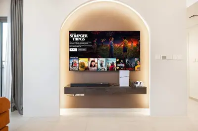 a living room with an archway with a flat screen tv at Prime Downtown Location 2BR Walk to Dubai Mall in Dubai