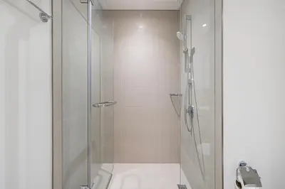 a bathroom with a shower with a glass door at Prime Downtown Location 2BR Walk to Dubai Mall in Dubai