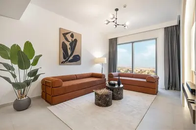 a living room with two couches and a large window at Prime Downtown Location 2BR Walk to Dubai Mall in Dubai