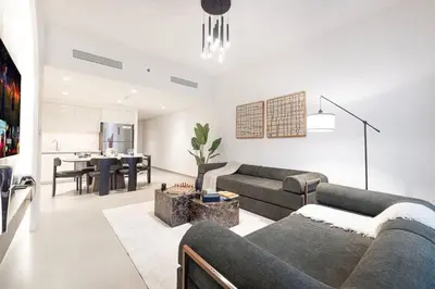 a living room with a couch and a table at Elegant 2BR Downtown Dubai Walk to Dubai Mall in Dubai