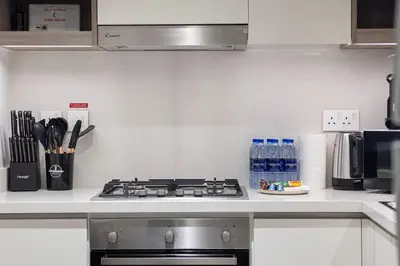 a kitchen counter with a stove top in a kitchen at Elegant 2BR Downtown Dubai Walk to Dubai Mall in Dubai