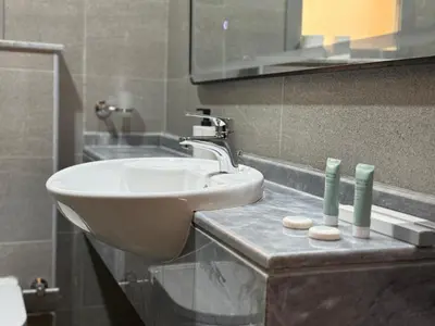 a bathroom with a sink and a mirror at Signature Grand Studio Apartment in Dubai