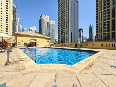 a swimming pool in a city with tall buildings at Elegant and Spacious 3-bedroom in JBR in Dubai