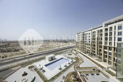 an aerial view of a building with a swimming pool at Bloomfields Cozy 1br In Rukan in Dubai