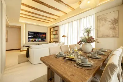 a living room with a table and a couch at Premium Corner 3BR, Sea Views with Sunset, 85 inch TV in Dubai