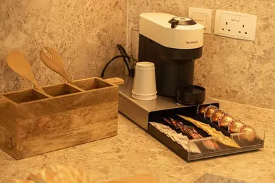 a coffee maker sitting on a counter next to a box at Premium Corner 3BR, Sea Views with Sunset, 85 inch TV in Dubai