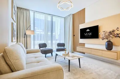 a living room with a couch and a tv at STAY BY LATINEM Luxury 2 BR Plus Maid Holiday Home CD 0208 Near Burj Khalifa in Dubai