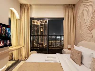 a bedroom with a large bed and a large window at Royal Vista - Stunning Boho Style 1BR with 5 Star Amenities in Dubai