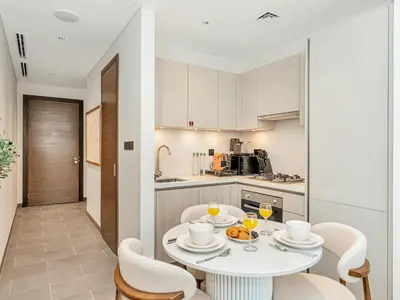 a kitchen and dining room with a table and chairs at Royal Vista - Stunning Boho Style 1BR with 5 Star Amenities in Dubai