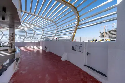 a building with a wooden ceiling and a red floor at Bright studio oplaz by Danube Near Miracle Garden in Dubai