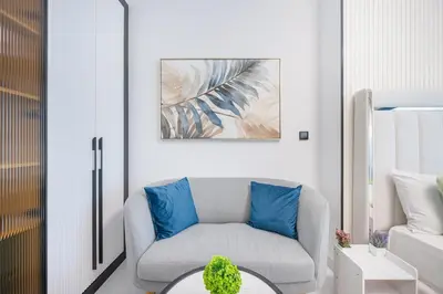 a living room with a couch and a table at Bright studio oplaz by Danube Near Miracle Garden in Dubai