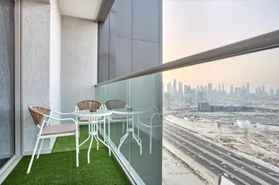 a balcony with a table and chairs and a view of the city at STAY BY LATINEM Luxury 1BR Holiday Home CVR A3304 near Downtown in Dubai