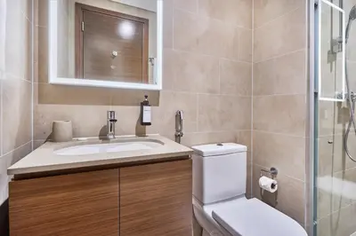 a bathroom with a toilet and a sink and a shower at STAY BY LATINEM Luxury 1BR Holiday Home CVR A3304 near Downtown in Dubai