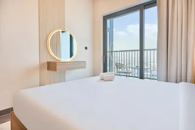 a bedroom with a large bed and a large window at STAY BY LATINEM Luxury 2BR Holiday Home CB 1215 Near Burj Khalifa in Dubai