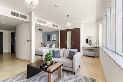 a living room with a couch and a bed at Silkhaus Gallery Studio at Sky Gardens in DIFC in Dubai