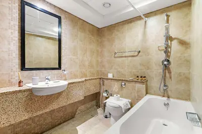 a bathroom with a tub and a sink and a toilet at Silkhaus Gallery Studio at Sky Gardens in DIFC in Dubai