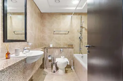 a bathroom with a sink and a toilet and a shower at Silkhaus Gallery Studio at Sky Gardens in DIFC in Dubai