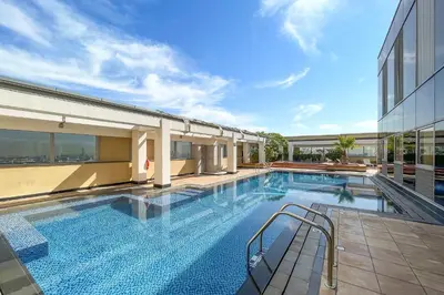 a large swimming pool next to a building at Silkhaus Gallery Studio at Sky Gardens in DIFC in Dubai