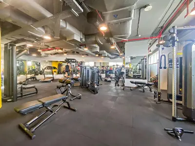 a gym with several treadmills and cardio machines at Silkhaus Premium 1BDR Stay with DIFC Views in Dubai