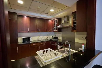 a kitchen with a sink and a dish basket on the counter at Full Burj Khalifa and Fountain Views 2BHK Apartment by WS Holiday Homes in Dubai