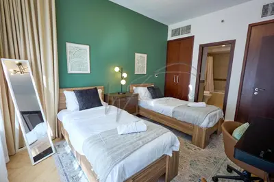a hotel room with two beds and a mirror at Full Burj Khalifa and Fountain Views 2BHK Apartment by WS Holiday Homes in Dubai