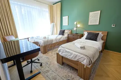 a bedroom with two beds and a desk in it at Full Burj Khalifa and Fountain Views 2BHK Apartment by WS Holiday Homes in Dubai