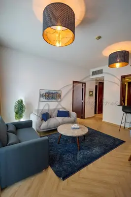 a living room with a couch and a table at Full Burj Khalifa and Fountain Views 2BHK Apartment by WS Holiday Homes in Dubai