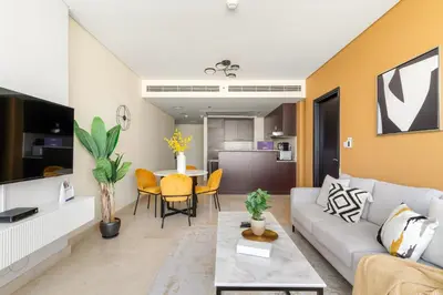 a living room with a couch and a table at Silkhaus Classic 1BDR in DIFC at Sky Gardens in Dubai
