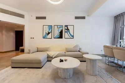 a living room with a couch and two tables at TRPS - Fairmont North Residences, Palm Jumeirah - Luxurious 2BR plus Maids, Sea and Harbour View in Dubai