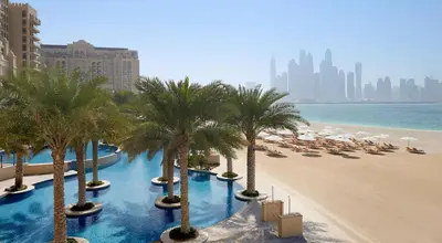 a view of a beach with palm trees and umbrellas at TRPS - Fairmont North Residences, Palm Jumeirah - Luxurious 2BR plus Maids, Sea and Harbour View in Dubai
