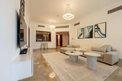 a living room with a couch and a table at TRPS - Fairmont North Residences, Palm Jumeirah - Luxurious 2BR plus Maids, Sea and Harbour View in Dubai