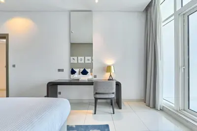 a bedroom with a desk and a chair at FAM Living - 1 Bedroom Canal View in DAMAC Maison Prive in Dubai