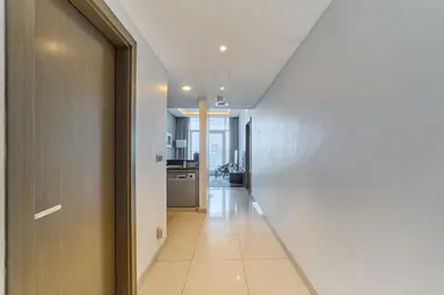 a hallway leading to a kitchen in a house at FAM Living - 1 Bedroom Canal View in DAMAC Maison Prive in Dubai