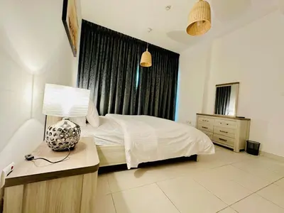 a bedroom with a bed with a lamp and a window at Marina View Towers - Dubai Marina Walk Access - View - 1BHK - Marsa in Dubai