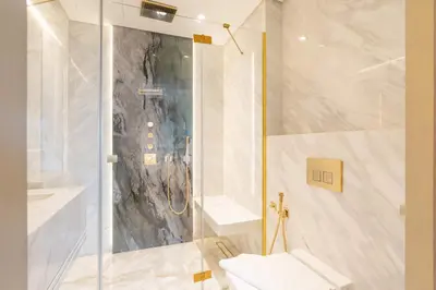a bathroom with a shower and a toilet at PVH - Burj Khalifa View Studio - Emaar Residences in Dubai
